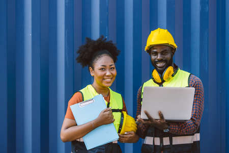 African teen black woman staff worker teamwork man and woman team work in port cargo industry happy smileの写真素材