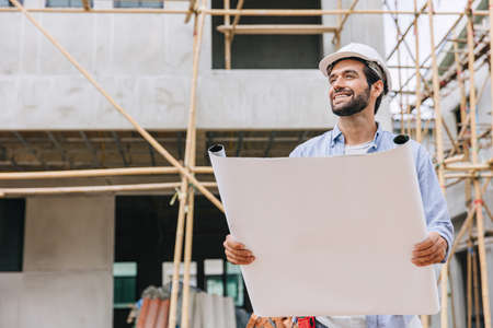 Engineer builder. Happy Foreman work in construction site. senior worker project designer leader concept.の写真素材