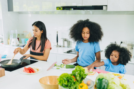 Mom with children cooking healthy food at home kitchen activity holiday.の写真素材