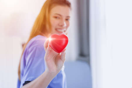 Heart Love Cardio Healthcare Medical concept with Beautiful Nurse Happy Smile.の写真素材