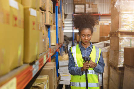 Staff worker work in warehouse inventory products collection management with barcode scanning device.の写真素材