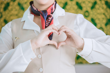air hostess ground airline staff customer service with care mind heart sign gesture conceptの写真素材