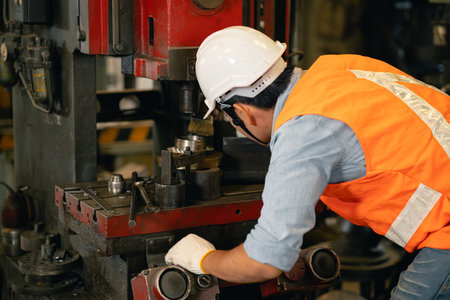 Industry male engineer worker safety check machine service fix setup working in lathe steel metal factoryの写真素材