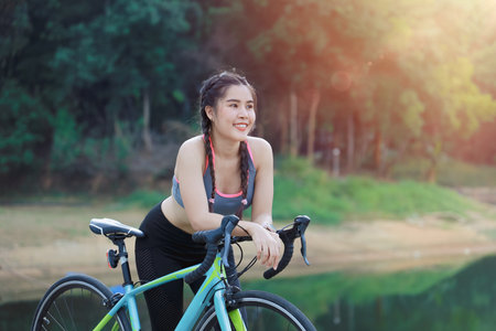 Road Bicycle outdoors sport teen girl happy smiling with cycling activity for healthy lifestyle conceptの写真素材