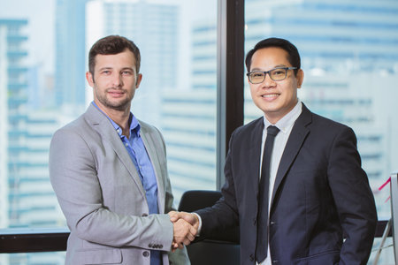 executive businessman hand shake finish dealing project business friend relationship mix race happy smilingの写真素材