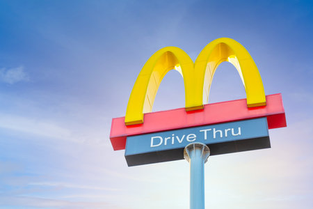 McDonald's Drive Thru Sign post McDonald largest fast food restaurant chain from American popular in hamburger french fries. 3 January 2023.Bangkok,THAILAND.のeditorial素材