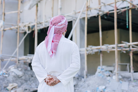 Sheikh Arab man looking at under construction building for build new office business project owner...