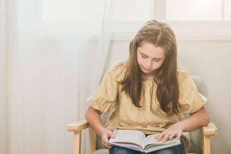 cute child girl reading a book at home for bookworm nerdy smart kid learning self education