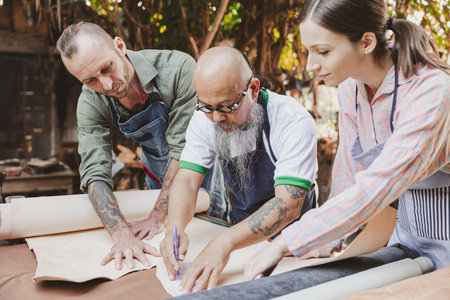 group of people leather handcraft artist and designer working together to selection best leather for new productsの写真素材