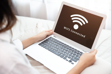 People using laptop connect to Internet using WIFI access point home network systemの写真素材