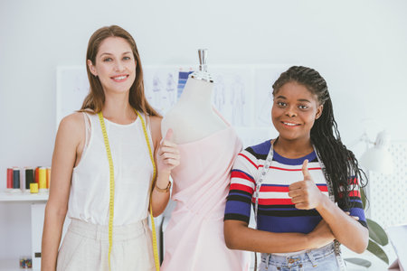 Tailor Dressmaker Professional Fashion Clothes Designer Team Work Working Together at Clothing Studio Workshopの写真素材