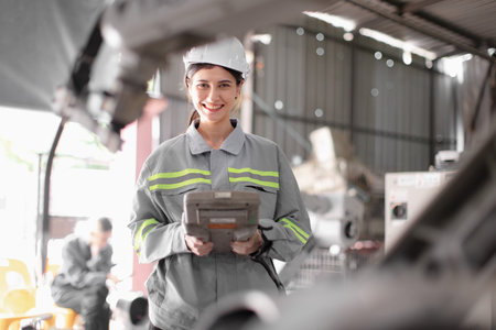 Engineer woman team worker work in Machine Robotic modern Automation Industry. Mechanic staff...
