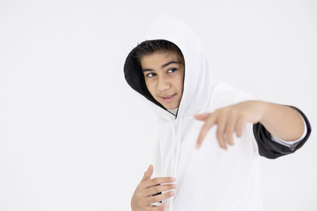 young boy teenager in hiphop dancing action on white backgroundの写真素材