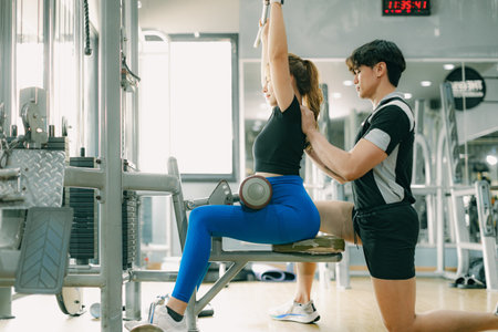 sport woman exercise chest muscle with lat pull down in gym with personal trainer male take care