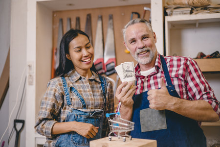 happy home builder handyman service business success show cash money satisfied with project incomeの写真素材