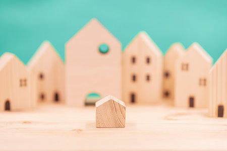 Small house in the big city concept. little model wooden home in the wood village.の写真素材