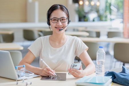 Portrait Asian university teen woman with books laptop education learning smart student lifestyle.の写真素材