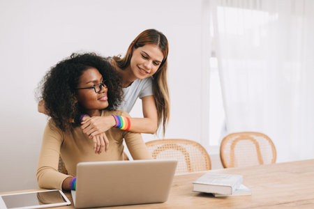 Couple woman lover LGBT family living together share love care looking together at homeの写真素材