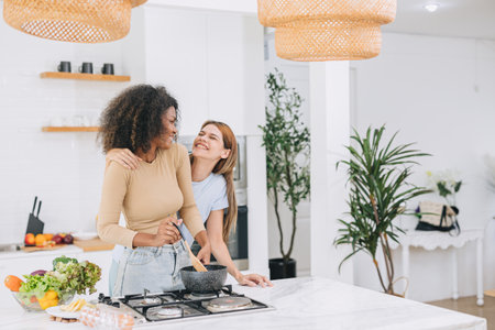 couple woman lover LGBT friend living with love care cooking at home holiday activity togetherの写真素材