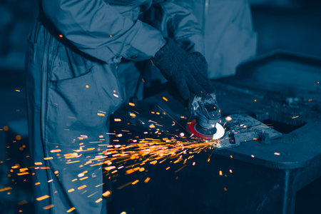 Industrial Worker Using Angle Grinder and Cutting a Metal Plate. Heavy Metal Industry Engineering...
