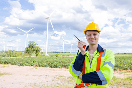 Portrait happy smiling engineer professional techician male working in wind turbines service...