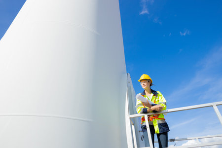 Engineer smart professional techician woman working service wind turbine sustainable eco power energy genrator from natureの写真素材