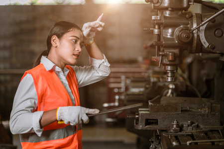 tired stress young woman worker sweating hard working in danger heavy metal industryの写真素材