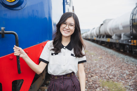 portrait happy asian woman lady on railway train station locomotive industry leisure relax smile imageの写真素材