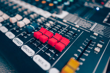 Sound mixer or concert sound engineer, closeup studio motorized volume level control sliders stero split channel deviceの写真素材