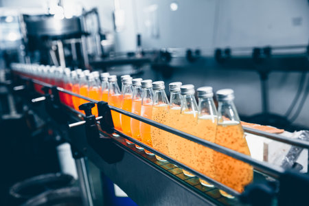 Drink factory automatic production working line. fruit juice beverage hygiene product at conveyor belt nobodyの写真素材