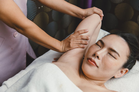 Chiropractor arm shoulder stretching woman relax in body spa for healthcare wellnessの写真素材