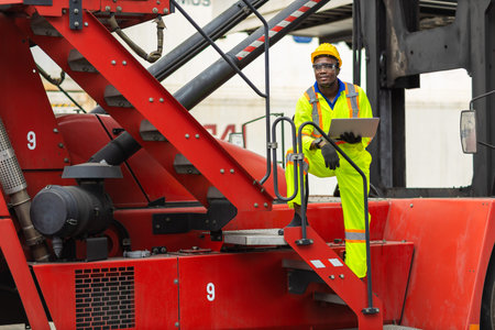 African male dock worker control loading containers cargo at warehouse container shipyard. Marine...