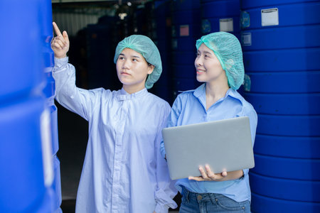 Water quality control officer engineer team inspect water tanks in beverage industry factory for...