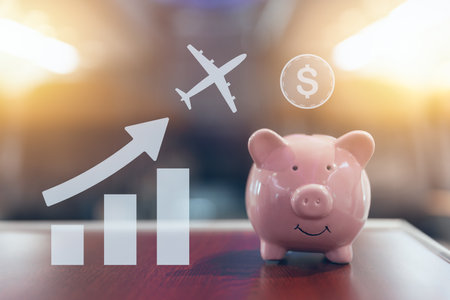 happy piggy bank on blur cabin for saving flight ticket low cost good value saving money business travel trip conceptの写真素材