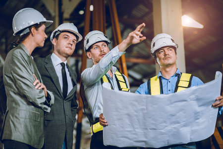 business investor meeting with engineer team with blue print floor plan looking survey at...
