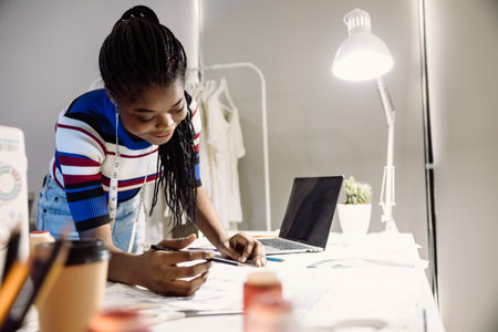 Tailor clothing designer staff worker happy working in cutting studio workshopの写真素材