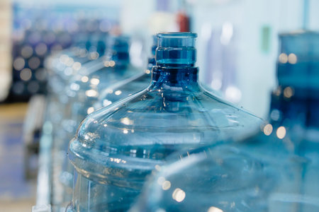 Plastic PET drinking water gallon bottle clean in conveyor production line in drink water plant...