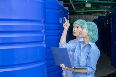 Water quality control officer engineer team inspect water tanks in beverage industry factory for ensure cleanliness standards.の写真素材