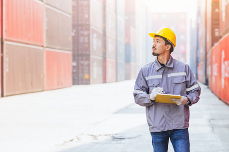 Japanese male smart worker working in container port cargo. Japan shipping logistics industry...