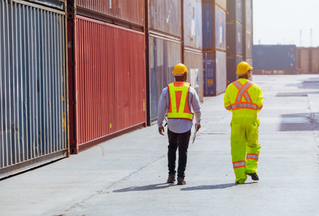 diversity model staff workers in port container yard logistics cargo shipping import export management industry teamwork.の写真素材