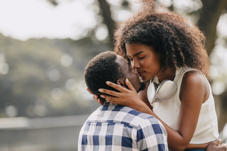 Date couple man and women valentine day. African black lover at park outdoors summer season vintage color toneの写真素材