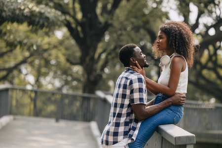 Date couple man and women valentine day. African black lover at park outdoors summer season vintage color toneの写真素材