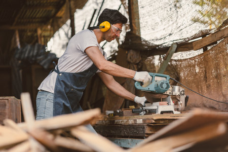 Carpenter man cut wood making masterpiece woodworks handcrafted make wooden furniture in wood workshop.の写真素材