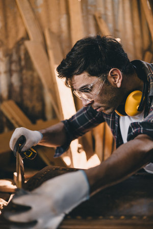 professional carpenter man hand working make wooden handcraft furniture master workpiece fine detail artisan with wood workshop.の写真素材