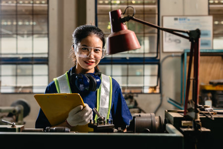 Portrait happy engineer worker with safety eyes protection glasses professional working with metal...