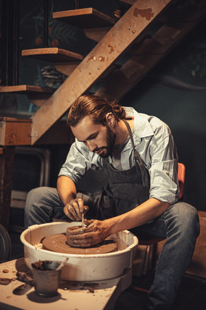 clay cup mug handcrafted man artist happy working proud look at finished hand craft product ceramic tea mug art project at workshopの写真素材