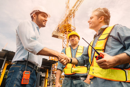 Workers team hand shaking deal with contractor happy at construction site. Engineer project business...