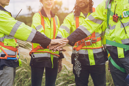 Group of Engineer team workers hand join together working cooperation strong force teamwork powerful concept.の写真素材