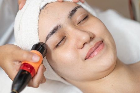 Beautiful women face skin treatment, Ultrasonic massage device for Facial Lifting Activate Collagen and Skin Tightening in beauty salon spa.の写真素材