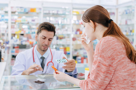 Woman is sick with a cold and has a runny nose. Buying medicine from the pharmacist at the drug store. Choose the type of medicine according to the instructions.の写真素材
